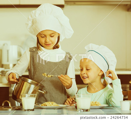 girls having breakfast with porridge 24264734