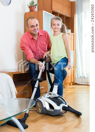 Man and little girl hoovering at home. 24265060