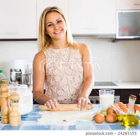 Girl making tasty pie indoors 24265155