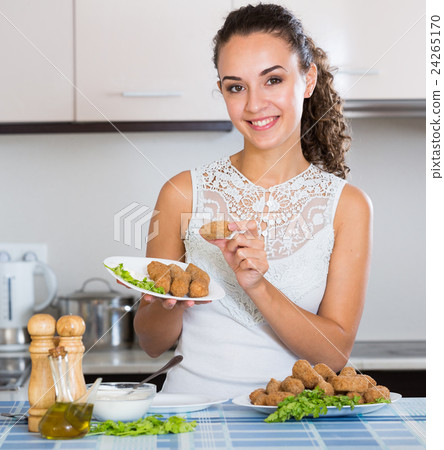 girl with tasty breadcrumbed crocchette girl with tasty breadcrumbed crocchette 24265170