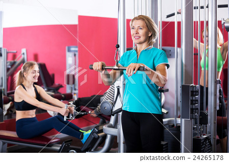 Adult people having strength training in gym 24265178