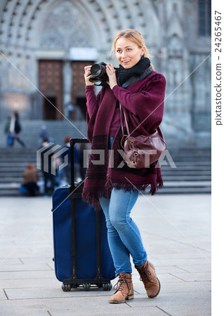 Young woman looking and taking pictures outdoors 24265467