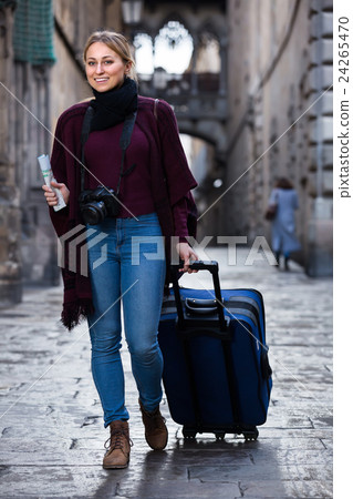 Tourist girl walking with the travel bag. 24265470