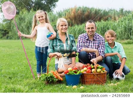 Family of four resting at countryside. 24265669