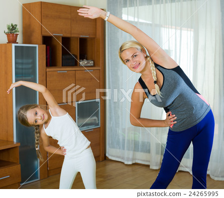 Sportive family of two having aerobics class at home Sportive family of two having aerobics class at home 24265995