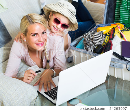 Family of two buying tickets online. Family of two buying tickets online. 24265997