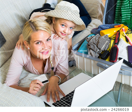Family of two buying tickets online. Family of two buying tickets online. 24266019