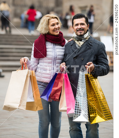 pensioners with shopping bags on city street 24266250