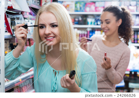 Portrait of adult women selecting black primer 24266826