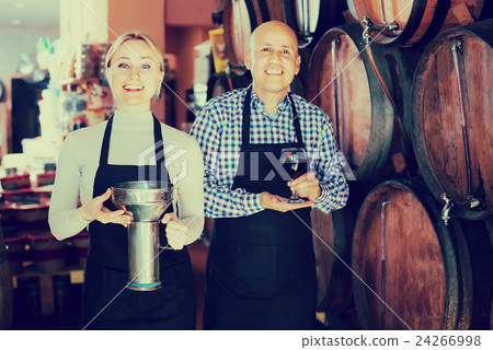 Portrait of two smiling wine makers taking wine 24266998