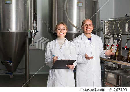 Man and woman working on brewery. Man and woman working on brewery. 24267103