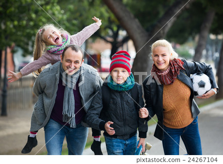 Portrait of family with two kids outdoors. Portrait of family with two kids outdoors. 24267104