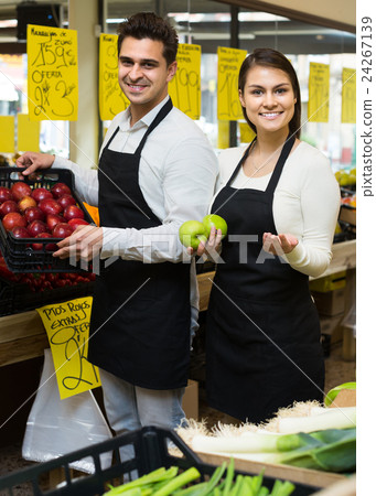 sellers offering seasonal sweet apples in grocery 24267139
