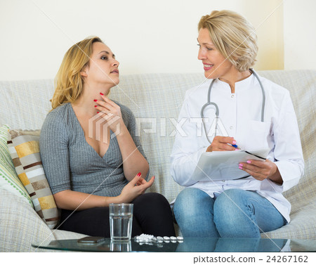 Young woman explaining mature doctor symptoms 24267162