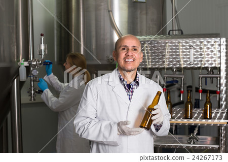 Man working on modern brewery. Man working on modern brewery. 24267173