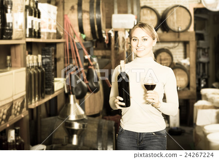 woman holding bottle of wine woman holding bottle of wine 24267224