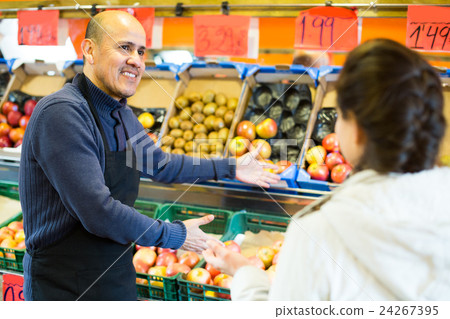 man offering customer fruits man offering customer fruits 24267395