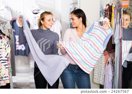Two women selecting sleepwear in store. 24267567