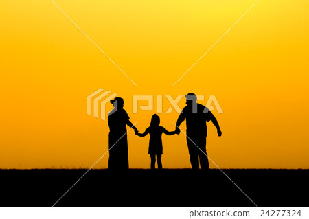 Silhouette of a family walking in sunset 24277324