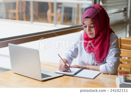 Muslim woman working with computer. 24282151