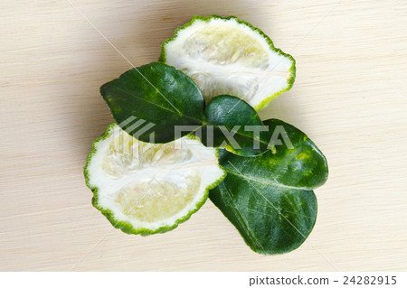 Bergamot fruit with leaf on wooden board Bergamot fruit with leaf on wooden board 24282915