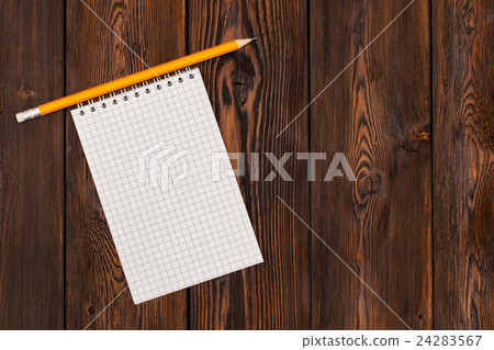 Blank notebook and pencil on a wooden background 24283567