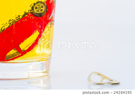 red toy car in a glass of beer isolated red toy car in a glass of beer isolated 24284195