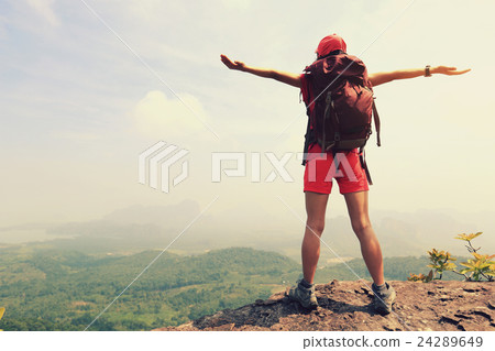 cheeringwoman backpacker open arms  mountain peak 24289649