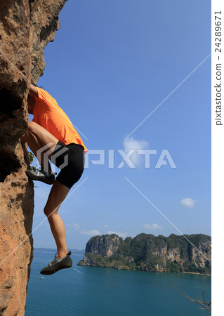 woman rock climber climbing seaside mountain rock woman rock climber climbing seaside mountain rock 24289671