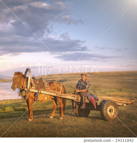 Horse Man Sitting On A Horse Cart In A Scenic View Of Nature Concept 24311842