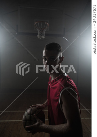 Portrait of basketball player holding a ball Portrait of basketball player holding a ball 24317673