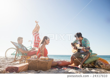Friends playing the guitar and dancing Friends playing the guitar and dancing 24317810