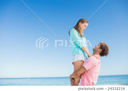 Happy couple posing on the beach Happy couple posing on the beach 24318216