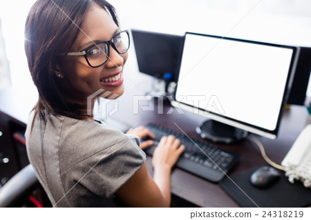 Casual businesswoman working on laptop Casual businesswoman working on laptop 24318219