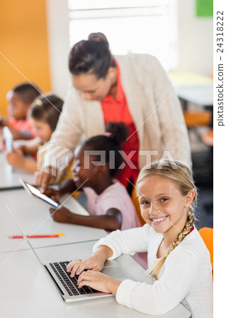 Teacher giving lesson to her students with technology 24318222