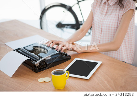 Hipster woman using a typewriter 24318298
