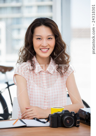 Hipster woman posing for the camera while sitting 24318301
