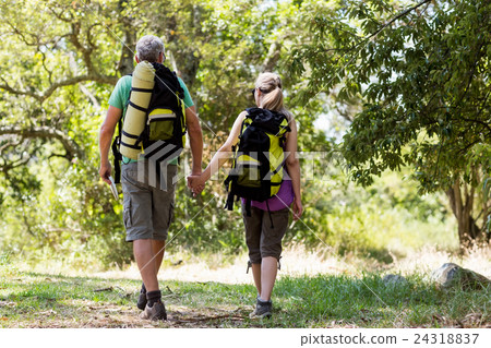 Couple hiking and holding hands each other Couple hiking and holding hands each other 24318837