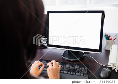Casual businesswoman working on laptop Casual businesswoman working on laptop 24319081