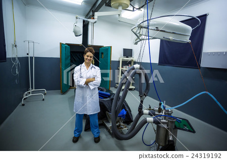 Woman vet smiling and posing with crossed arms 24319192