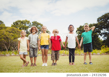 Happy children smiling and holding by hands Happy children smiling and holding by hands 24319296