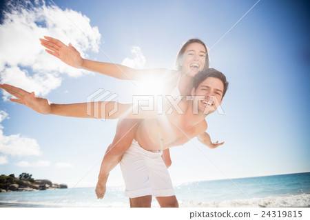 A handsome man holding his girlfriend A handsome man holding his girlfriend 24319815