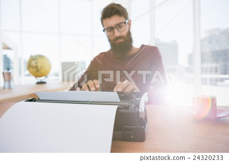 Hipster man using a typewriter Hipster man using a typewriter 24320233