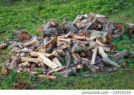 Stack of firewood on the grass Stack of firewood on the grass 24320234