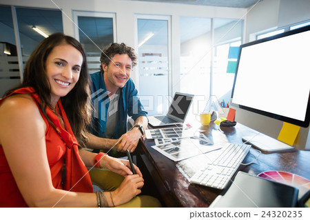 Colleagues using technology Colleagues using technology 24320235