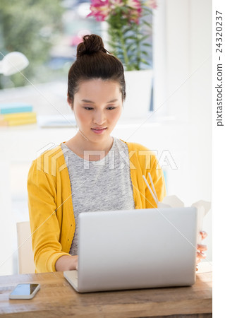 A business woman is working on her laptop A business woman is working on her laptop 24320237