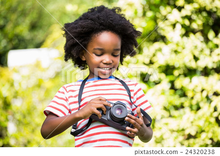 Boy looking at his camera Boy looking at his camera 24320238