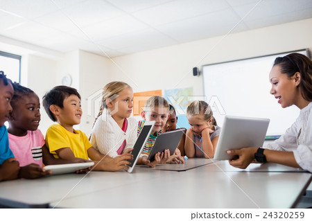 Teacher having lesson with tablet pc Teacher having lesson with tablet pc 24320259
