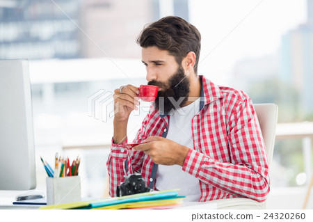 Hipster man is drinking a coffee Hipster man is drinking a coffee 24320260