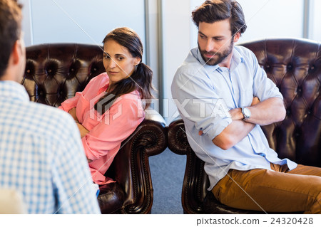 Psychologist helping a couple with relationship difficulties Psychologist helping a couple with relationship difficulties 24320428